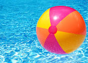 Thumbnail 22 of 23 - A colorful beach ball floating in a pool of water.
