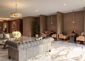 Thumbnail 3 of 16 - A modern living room with a large marble floor and a chandelier.
