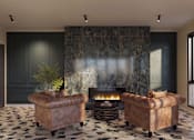Thumbnail 6 of 16 - A living room with a fireplace and two brown leather chairs.