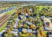 Thumbnail 31 of 34 - A suburban neighborhood with houses and trees in autumn colors.