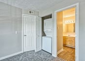 Thumbnail 16 of 21 - A white door is open to a bathroom.