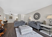 Thumbnail 4 of 32 - Living room at Renaissance at Carol Stream featuring a grey couch, white coffee table.