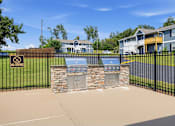 Thumbnail 24 of 27 - A black fence with a sign that says "No Diving" in front of a stone wall and a blue grill.