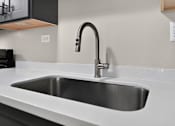 Thumbnail 3 of 32 - Kitchen sink with chrome faucet at Renaissance at Carol Stream in Carol Stream, IL.