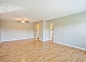 Thumbnail 8 of 21 - A room with wooden floors and a ceiling fan.