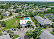 Thumbnail 32 of 32 - Aerial view of the Renaissance at Carol Stream community featuring homes, a swimming pool, and a parking lot in Carol Stream, IL.