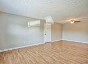 Thumbnail 14 of 21 - A room with wooden flooring and a ceiling fan.