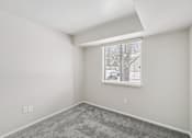 Thumbnail 10 of 31 - A room with a window and a grey carpet.
