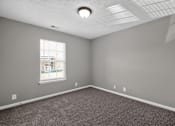 Thumbnail 11 of 18 - A room with a window and a carpeted floor.