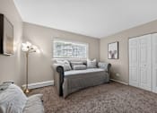 Thumbnail 7 of 32 - Bedroom at Renaissance at Carol Stream featuring a bed, lamp, and wall art in Carol Stream, IL.