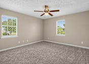 Thumbnail 7 of 27 - Room with a ceiling fan and two windows at Arbours at Victoria Place in Prattville, AL