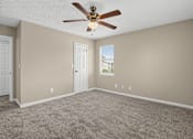 Thumbnail 9 of 27 - Bedroom with a ceiling fan and carpeted floor at Arbours at Victoria Place in Prattville, AL
