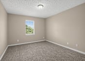 Thumbnail 11 of 27 - Room with a window and carpeted floor at Arbours at Victoria Place in Prattville, AL