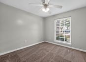 Thumbnail 6 of 30 - A room with a ceiling fan and a window with blinds.