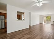 Thumbnail 3 of 35 - A spacious living room with a ceiling fan and hardwood floors.