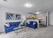 Thumbnail 2 of 39 - a living room with blue couches and a coffee table