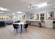 Thumbnail 19 of 32 - Clubhouse with shuffleboard table at Avalon Place Columbia SC