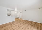 Thumbnail 6 of 31 - A room with wooden floors and white walls.