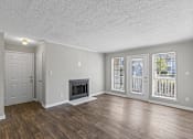 Thumbnail 5 of 25 - Room with fireplace and glass doors at Park at Meadow Ridge Montgomery AL