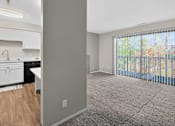 Thumbnail 5 of 34 - A kitchen with white cabinets and a window with blinds.