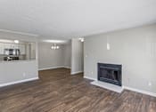 Thumbnail 4 of 25 - Living room with fireplace and wood floors at Park at Meadow Ridge Montgomery AL