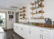 Thumbnail 4 of 23 - Modern kitchen with marble counters at Arbours at Victoria Place Prattville AL