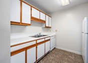 Thumbnail 17 of 23 - Kitchen with white cabinets at Arbours at Victoria Place Prattville AL