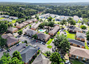 Thumbnail 27 of 30 - A bird's eye view of a residential area with houses and cars.