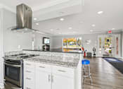 Thumbnail 23 of 32 - Kitchen with granite and stainless appliances at Bainbridge Park Canton MI