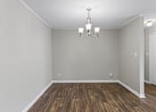 Thumbnail 7 of 25 - Room with wood floors and chandelier at Park at Meadow Ridge Montgomery AL