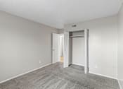 Thumbnail 15 of 22 - A room with a carpeted floor and a white door.