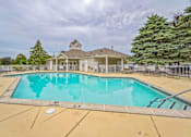 Thumbnail 25 of 31 - A pool with a house in the background.