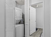 Thumbnail 20 of 39 - a laundry room with a washer and dryer and a white door