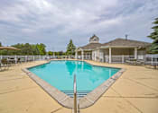 Thumbnail 19 of 31 - A swimming pool in a backyard with a house in the background.