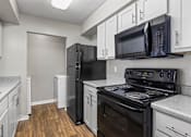 Thumbnail 3 of 25 - Kitchen with black appliances at Park at Meadow Ridge Montgomery AL