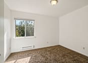 Thumbnail 11 of 35 - A room with a window and carpeted floor.