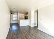 Thumbnail 3 of 16 - A room with wooden floors and white walls.