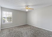 Thumbnail 12 of 25 - Carpeted room with ceiling fan at Park at Meadow Ridge Montgomery AL