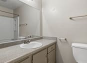 Thumbnail 19 of 22 - A bathroom with a sink, toilet, and bathtub.