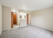 Thumbnail 36 of 39 - A spacious room with a carpeted floor and a door on the left side.