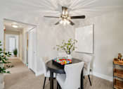 Thumbnail 5 of 32 - A dining room with a table set for four.