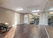 Thumbnail 24 of 32 - A spacious gym with treadmills and exercise bikes.