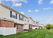 Thumbnail 19 of 25 - A row of houses with white picket fences.