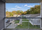 Thumbnail 14 of 26 - A view from a balcony overlooking a residential area.