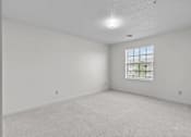 Thumbnail 19 of 39 - an empty room with white walls and a window