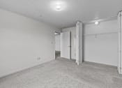 Thumbnail 9 of 39 - the living room is empty and has a door to the closet