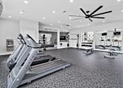 Thumbnail 15 of 38 - A gym with treadmills and other exercise equipment.