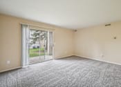 Thumbnail 13 of 31 - A room with a carpeted floor and sliding glass doors.