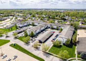 Thumbnail 35 of 39 - an aerial view of a parking lot and buildings in a city