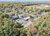 Thumbnail 20 of 26 - An aerial view of a residential area with houses and trees.